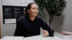 Allsolve sitting at a desk confidently.