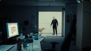 The engineer re-entering the room with a sheep.