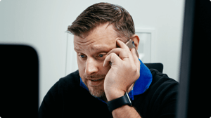 The team lead on the phone looking more annoyed.