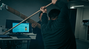 Two engineers battling with makesihft swords.