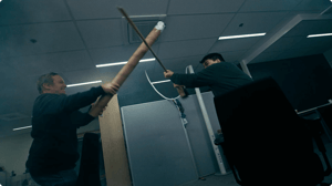 Battle continuing with broom stick and cardboard sword.