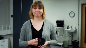 The boss with a coffee cup in her hand, displeased