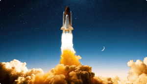 Space shuttle launches, emitting bright flames and smoke against a starry sky.