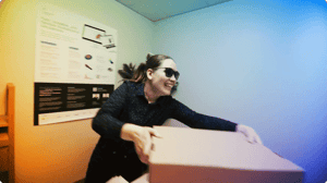 Allsolve in sunglasses handing over box.